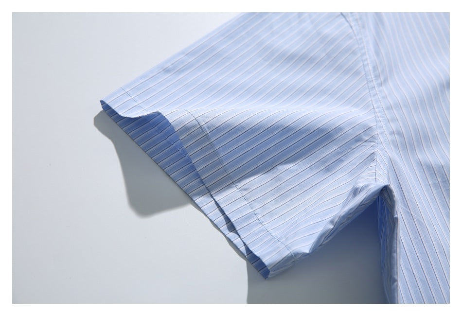 Close-up of the short sleeve and hem of a light blue shirt with narrow white stripes.