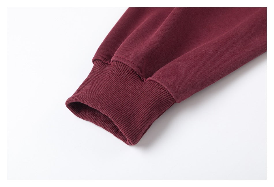 Close-up of a burgundy sleeve ending in a wide ribbed cuff.