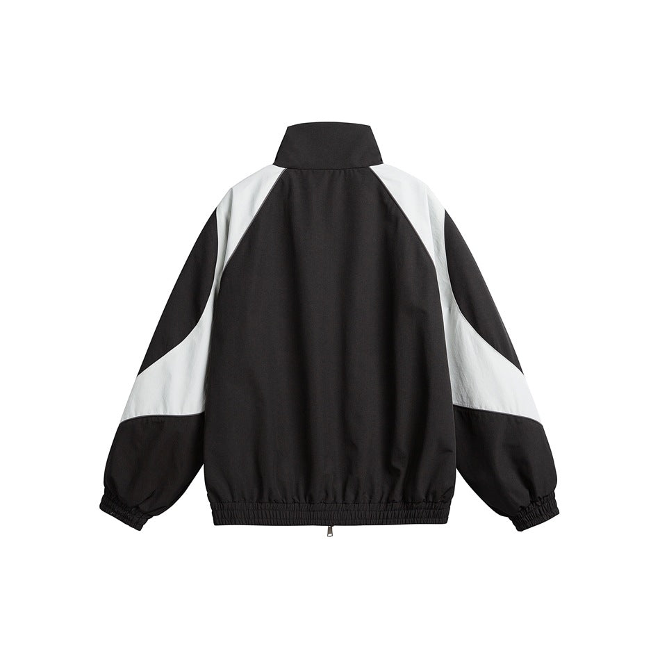 Back view of black jacket with light gray raglan-style panels, stand collar and elastic cuffs and hem