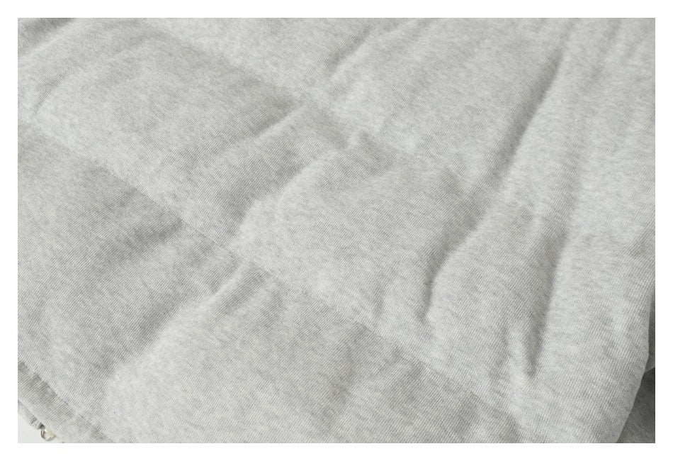 Close-up of the heathered light gray garment fabric and its subtle surface texture.