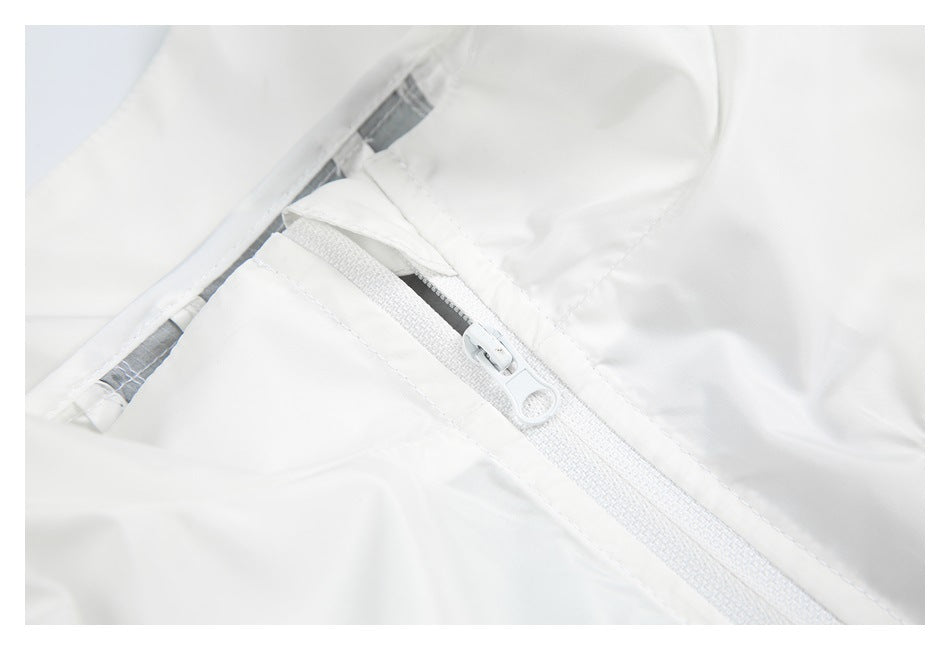 Close-up of a white zipper opening with gray lining on a white garment.