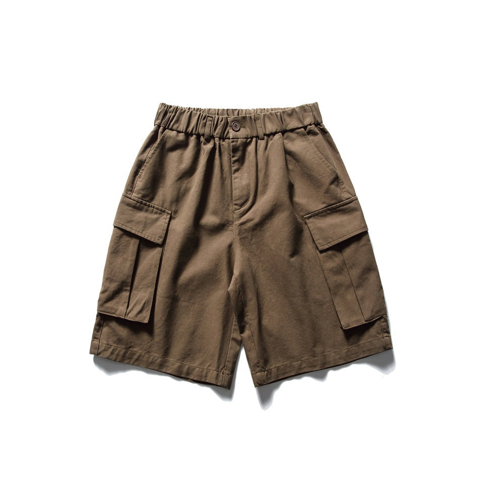 Front view of dark brown cargo shorts with a gathered waistband, button closure and large side pockets.