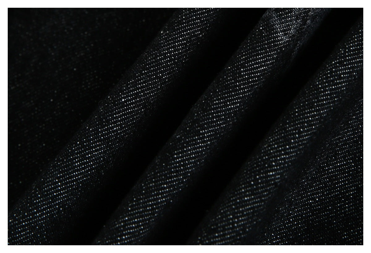 Macro view of black fabric in folds, showing its fine woven texture.