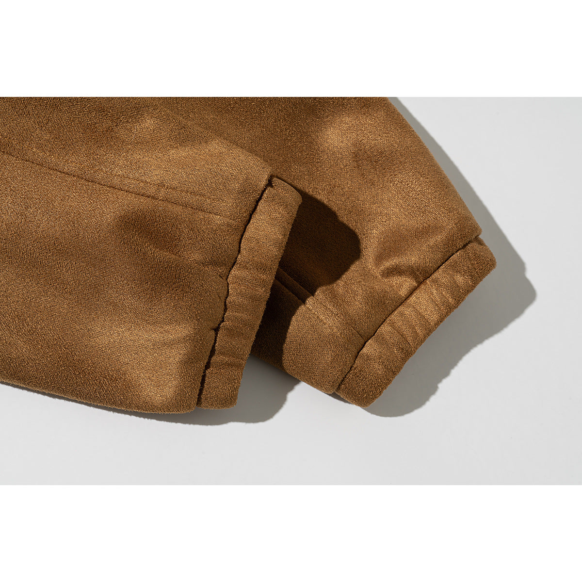Close-up of the brown jacket's sleeve and gathered cuff.