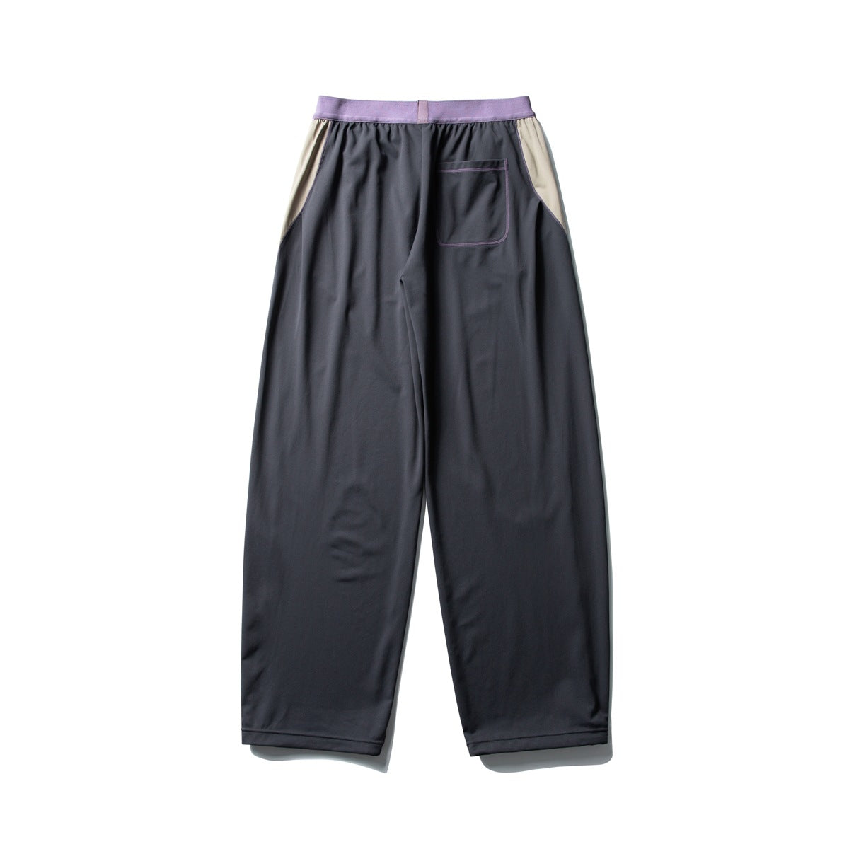 Back view of charcoal wide-leg pants with a lilac waistband, beige side panels, and a single patch pocket.