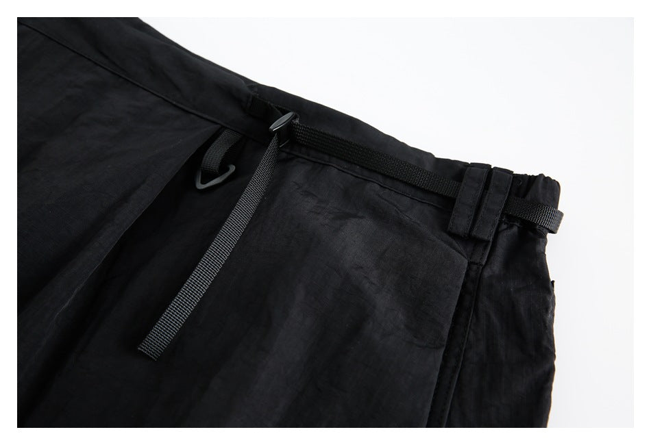 Close-up of the black skirt waistband with adjustable webbing, loops and a plastic hook.