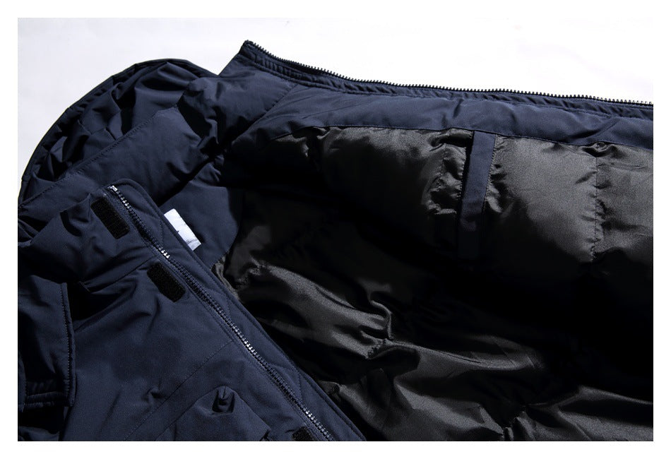 Close-up of a dark navy garment opened to show its black lining, zipper, and interior construction.