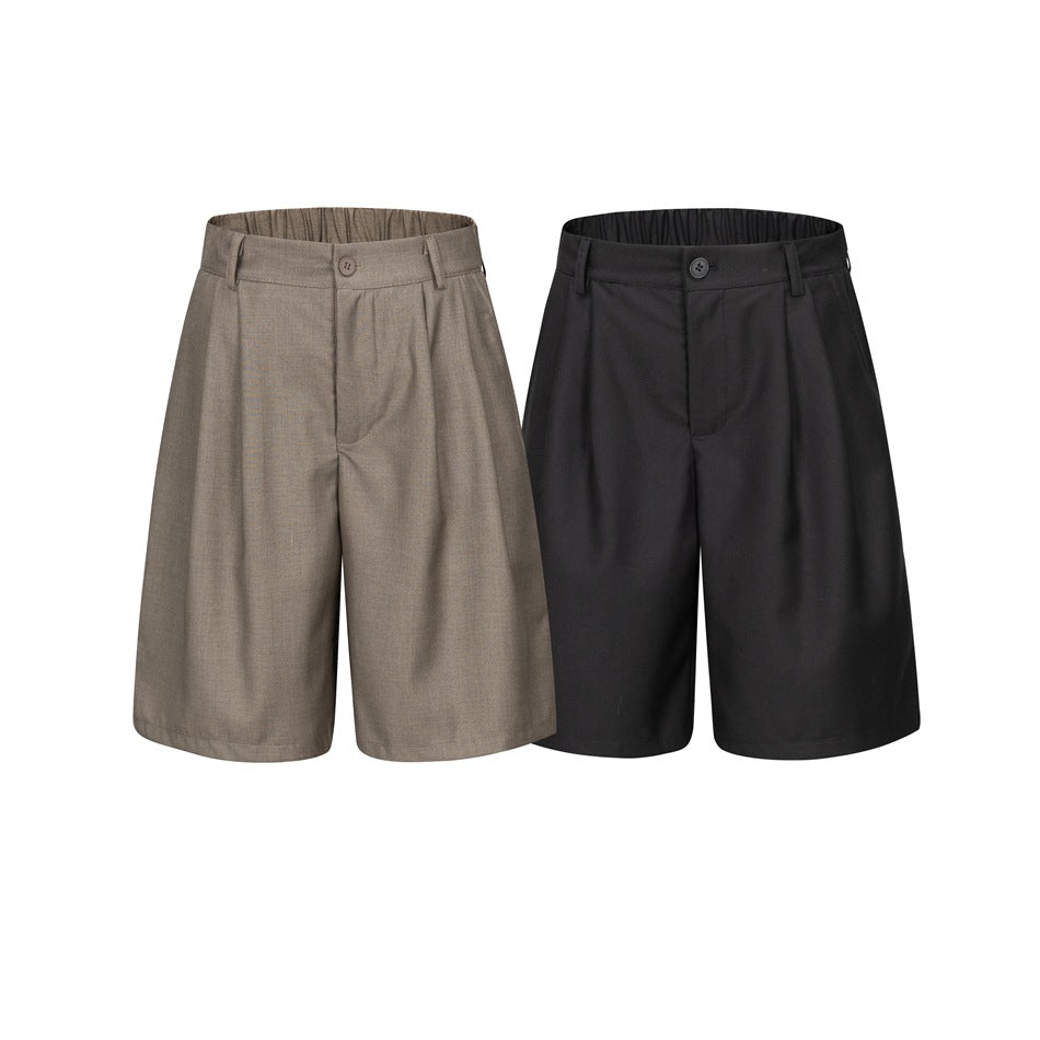 Front view of pleated shorts in taupe and black, shown side by side on a white background.