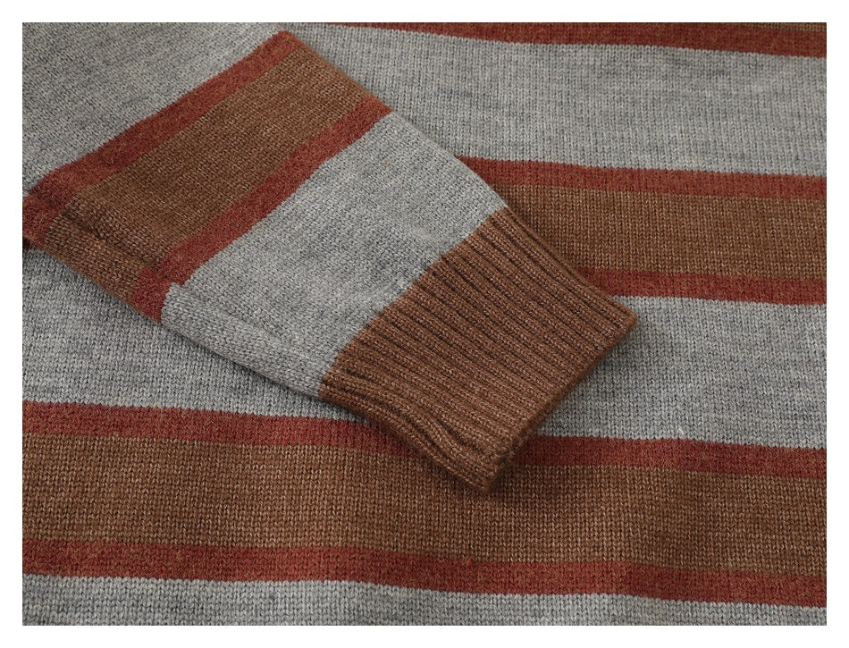 Close-up of a sleeve and ribbed brown cuff against the sweater's brown, gray, and rust stripes.