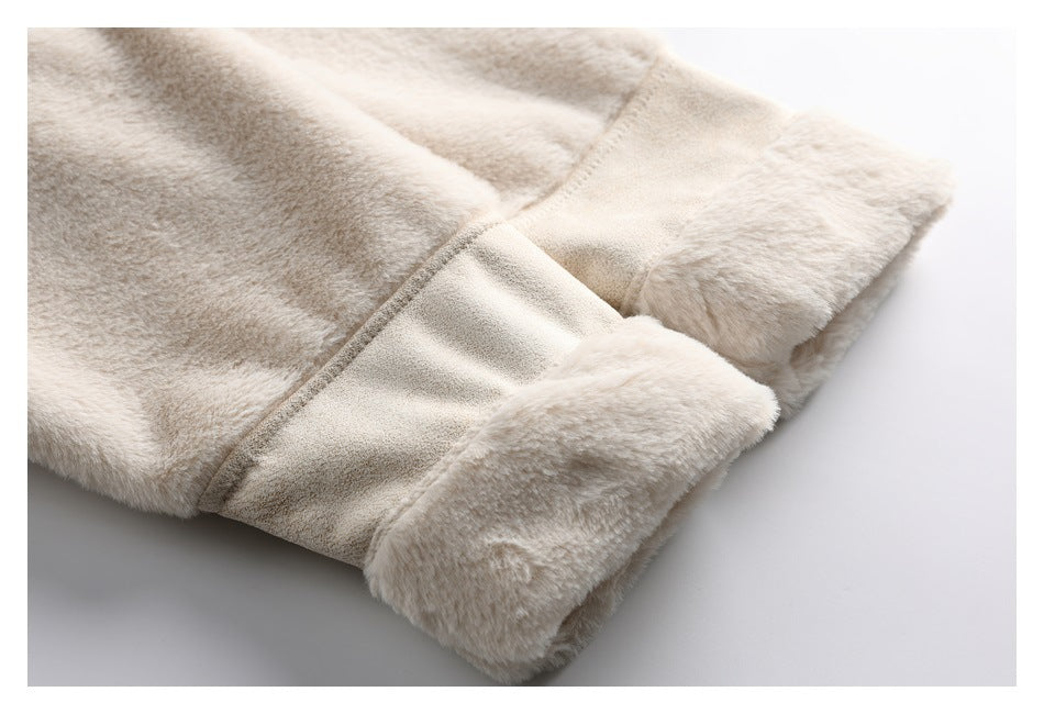 Close-up of the cream coat's plush sleeve cuff and seam on a white background.