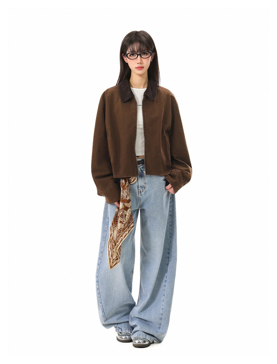 Model wearing open brown cropped jacket with dark collar over a white top, light wide-leg jeans and a printed scarf