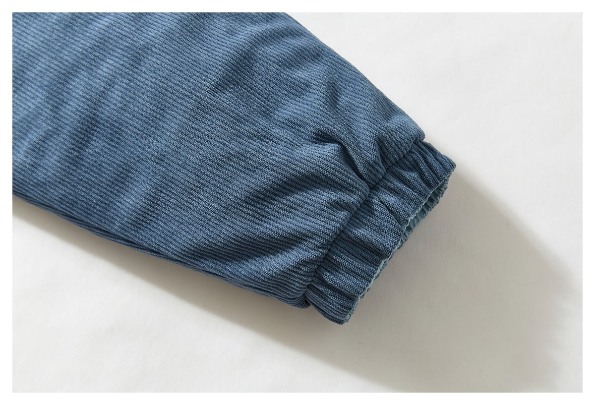 Close-up of a blue ribbed jacket sleeve ending in an elasticated cuff.