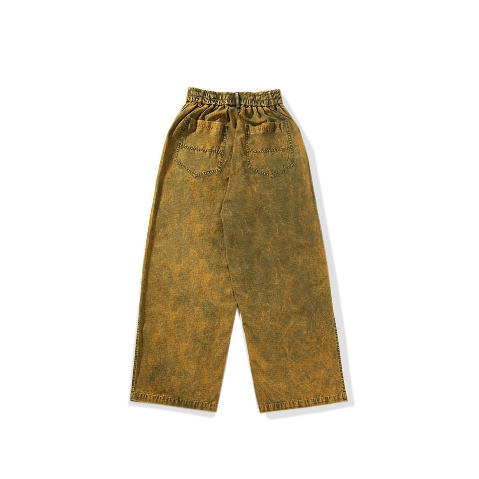 Full rear view of ochre-brown wide-leg trousers with a gathered elastic waistband and two back pockets.