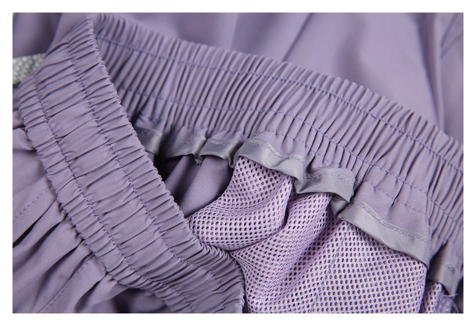 Close-up of lavender shorts showing a gathered elastic waistband and breathable mesh lining.