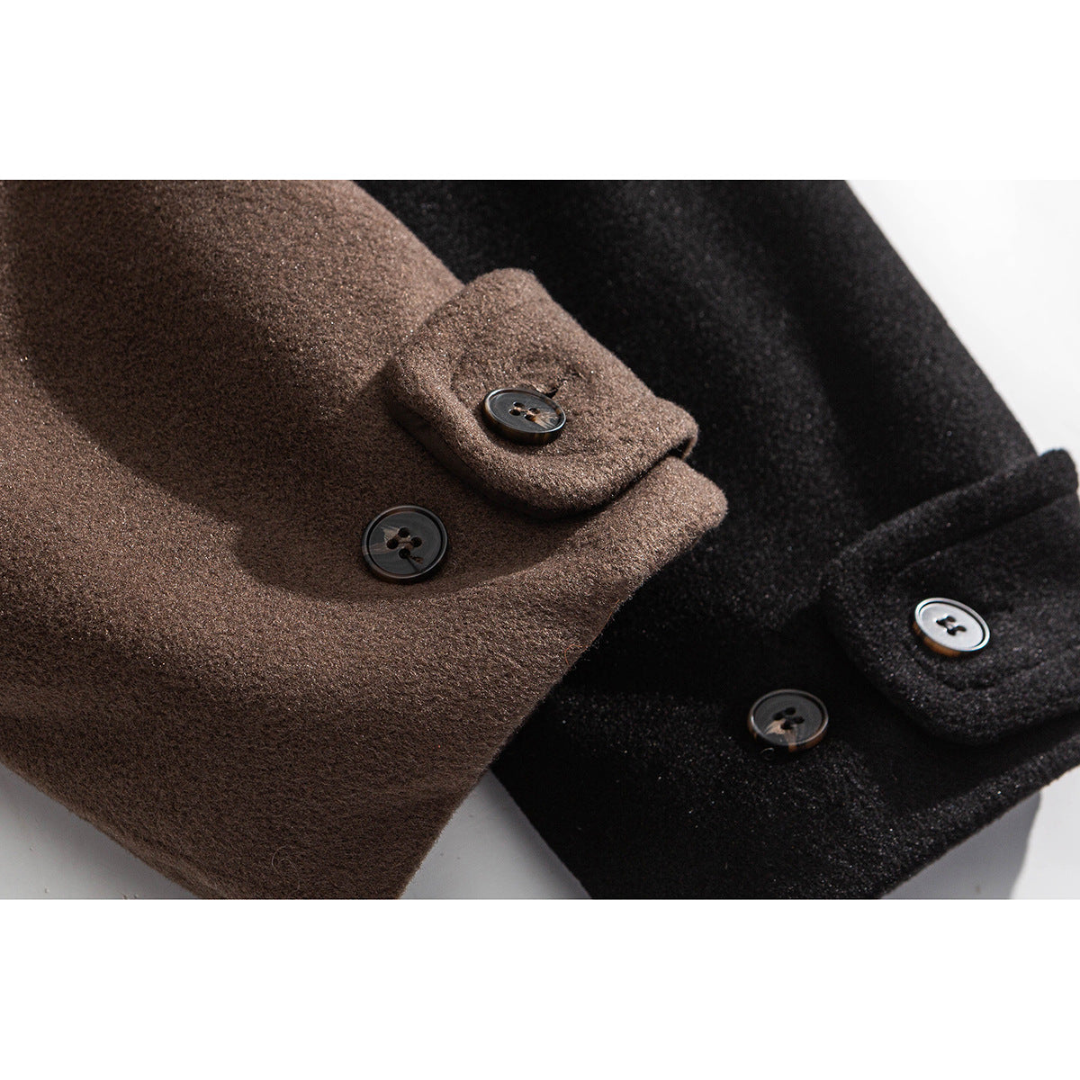 Close-up of buttoned cuff tabs on brown and black coats.
