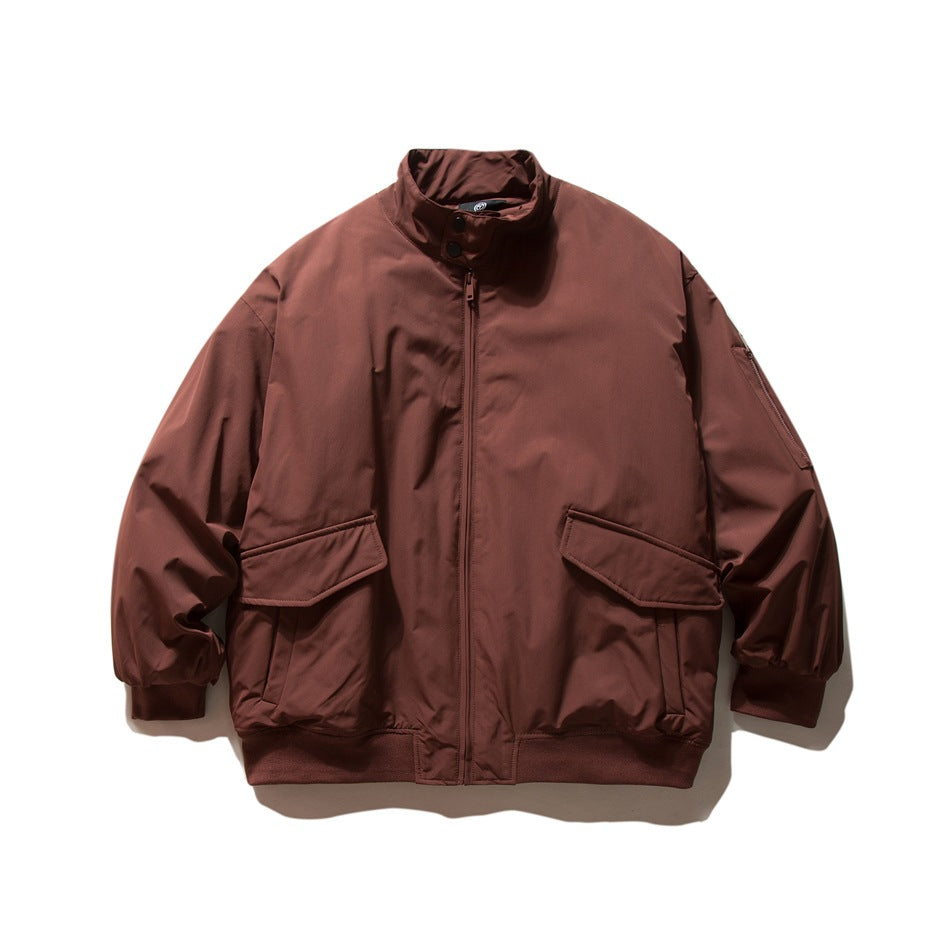 Burgundy stand-collar zip jacket with large flap pockets and ribbed cuffs and hem, flat lay front view