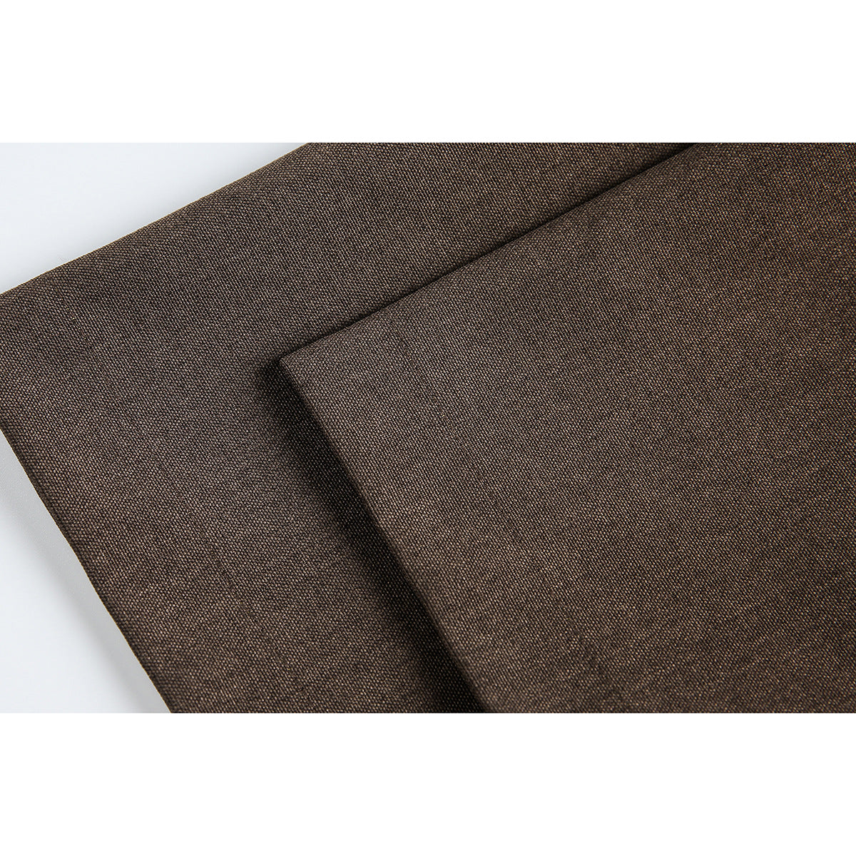Close-up of the brown garment's textured fabric and folded edge.