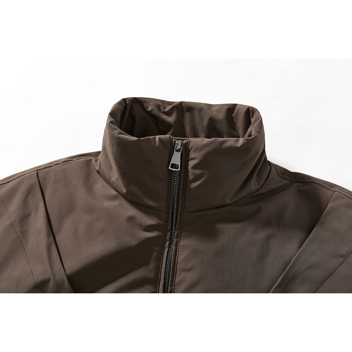 Close-up of a brown jacket’s high stand collar and front zipper.