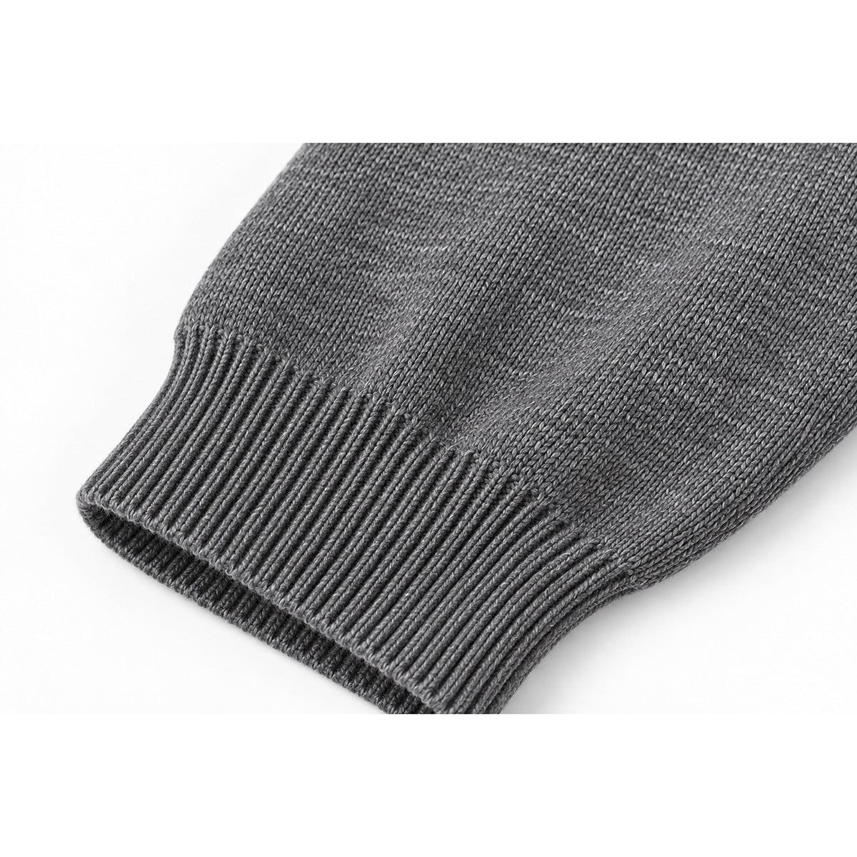 Close-up of a gray sweater sleeve ending in a wide ribbed cuff.