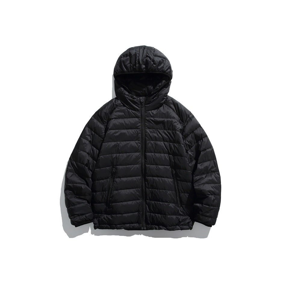 Black hooded quilted puffer jacket, front flat view with center zipper and zip pockets