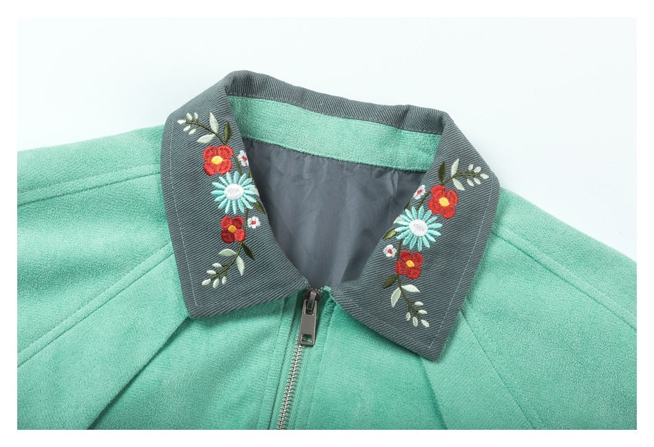 Close-up of the jacket's gray collar with colorful floral embroidery and a front zipper.