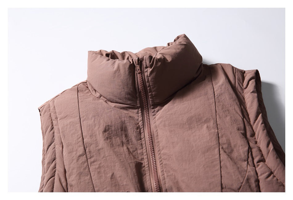 Close-up of a dusty mauve sleeveless vest with a tall padded collar and front zipper.