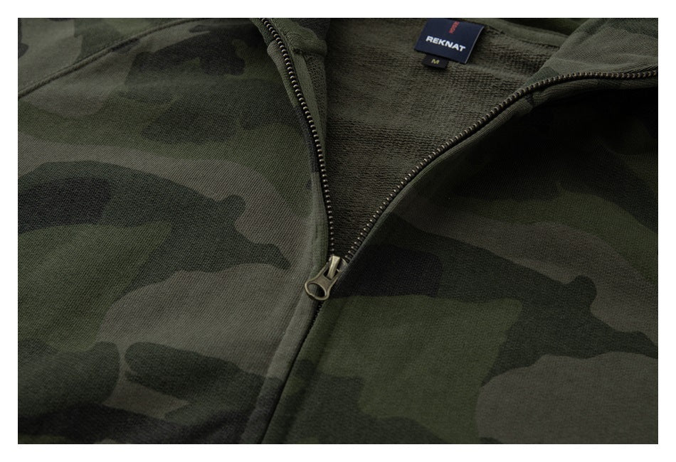 Close-up of the open zipper, camouflage fabric, and inside neck label of an olive camouflage hoodie.