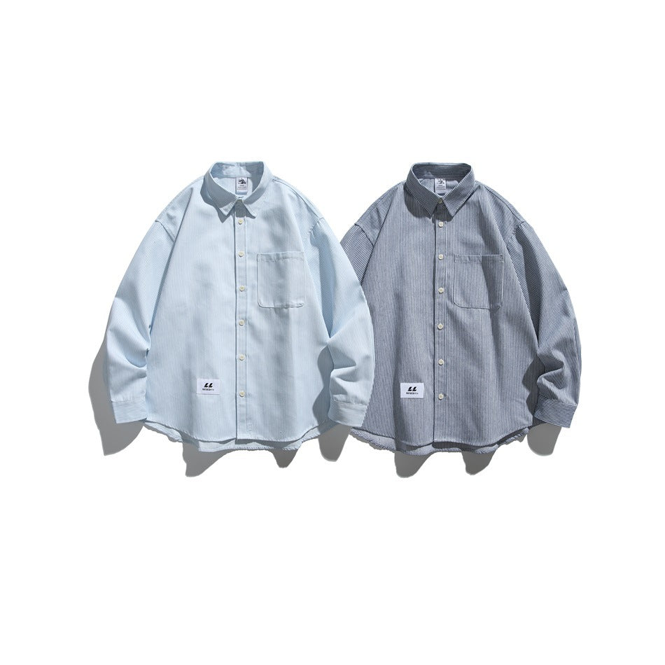 Two long-sleeved button-up shirts with chest pockets, one pale blue and one dark gray, both finely striped.