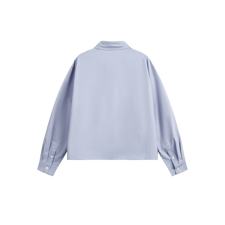 Back view of a pale lavender long-sleeve collared shirt with button cuffs, isolated on a white background.