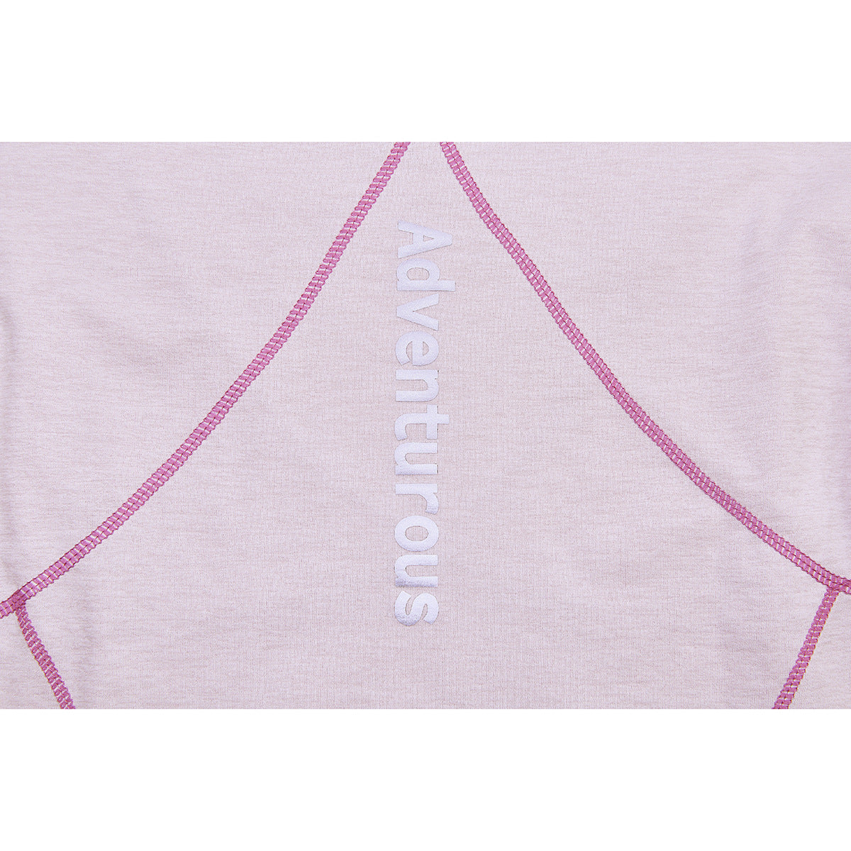 Close-up of pale lavender fabric with pink curved seam lines and vertical white “Adventurous” lettering.