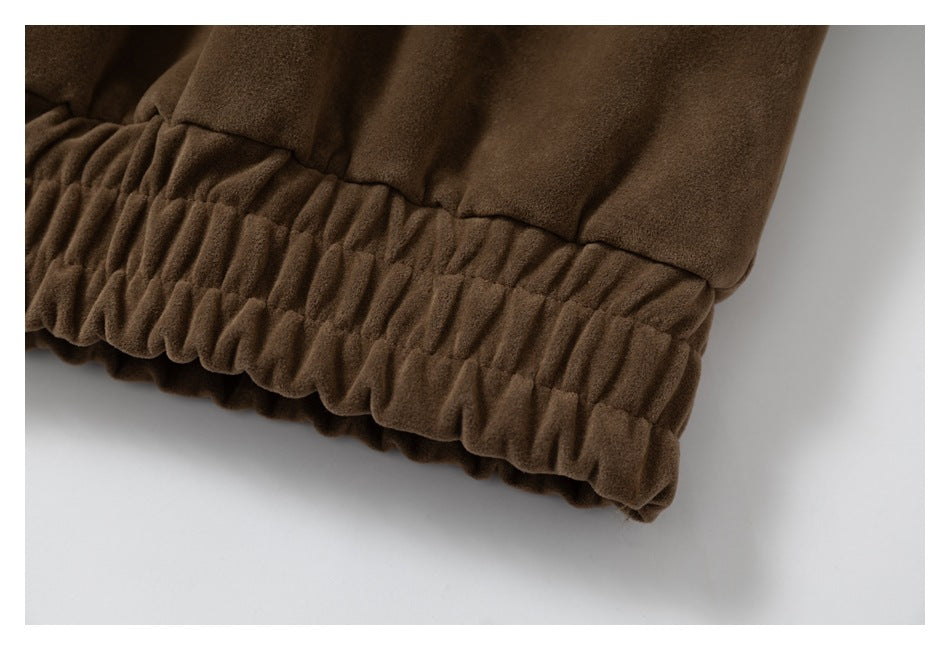 Close-up of the gathered elastic hem on a brown garment.