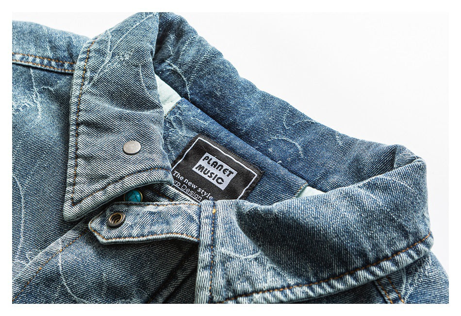 Close-up of a blue denim jacket collar, snap, and sewn-in English label.