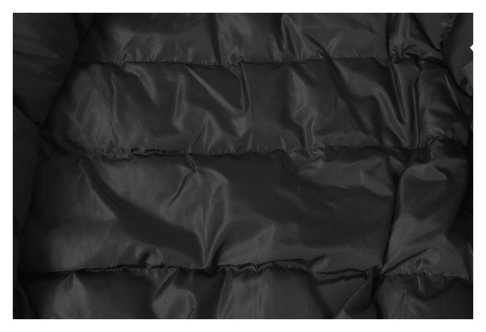 Close-up of the black jacket's padded, horizontally stitched lining.
