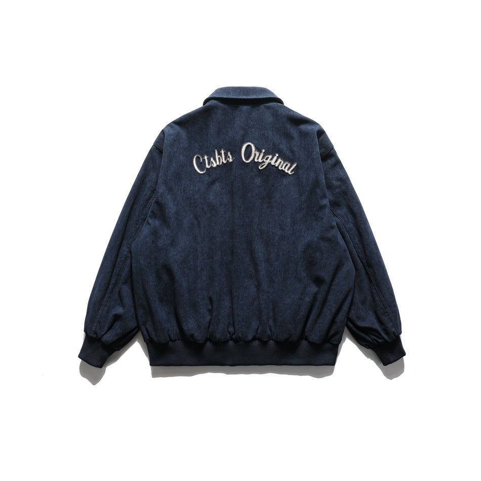 Back view of a navy jacket with white script embroidery across the upper back.