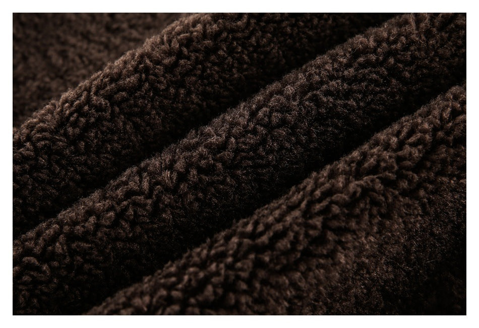 Close-up of dark brown, thick, curly pile fabric gathered into soft folds.