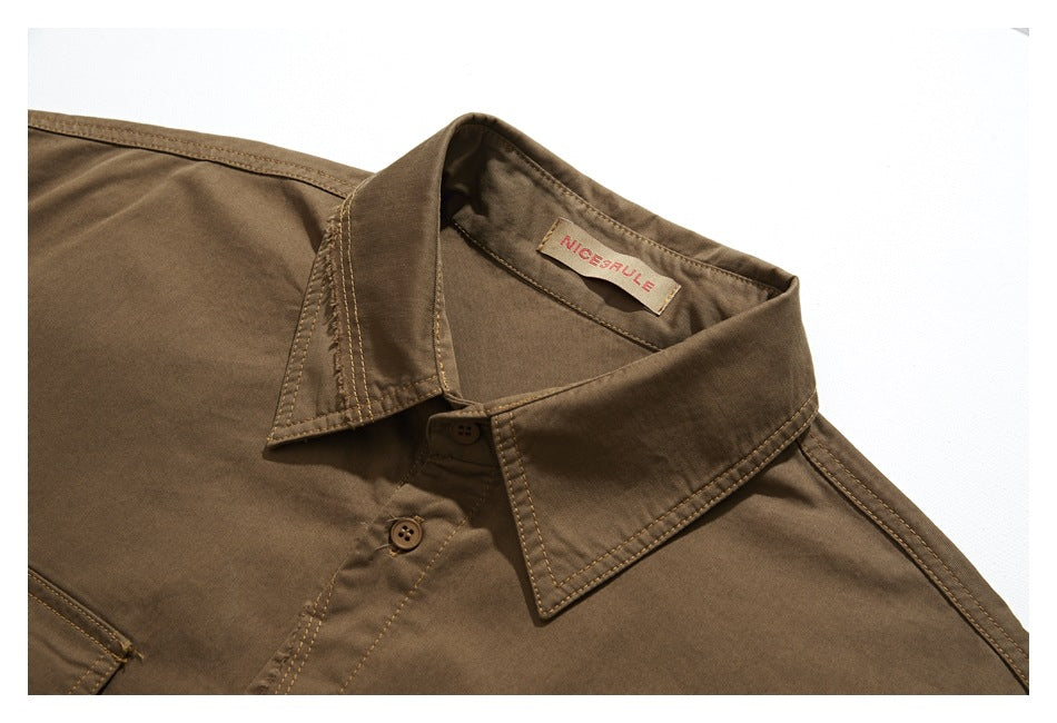 Close-up of the brown shirt's pointed collar, buttons, stitching, and sewn-in neck label.