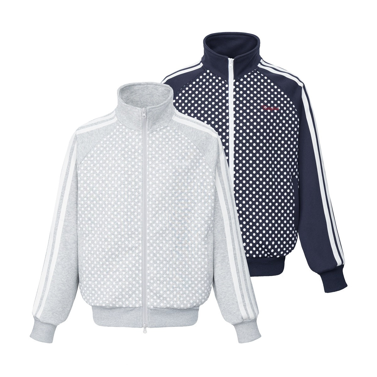Two zip-front track jackets with raised collars and polka-dot fronts: light gray and navy, both with striped sleeves.