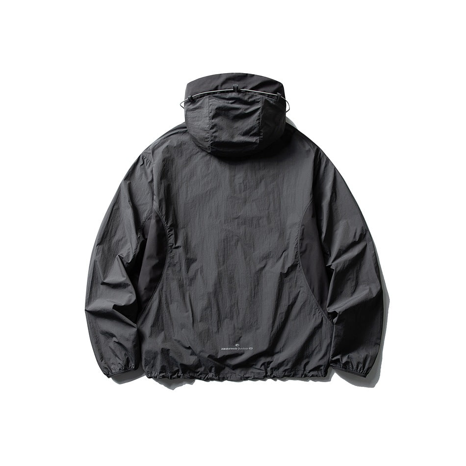 Rear view of a charcoal hooded jacket with an adjustable hood cord and gathered cuffs and hem.