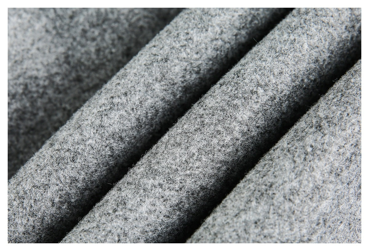 Macro view of the jacket’s mottled gray textured fabric folded into soft ridges.