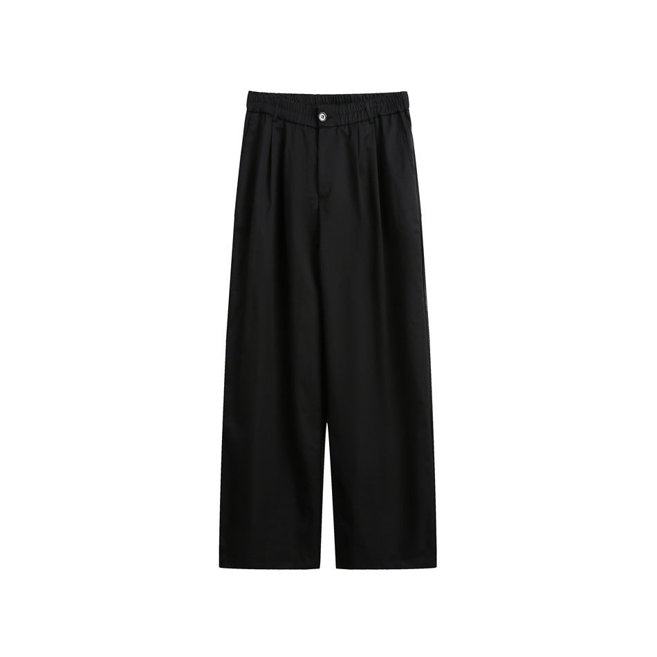 Black wide-leg trousers shown from the front, with an elastic waistband, button, and front pleats.