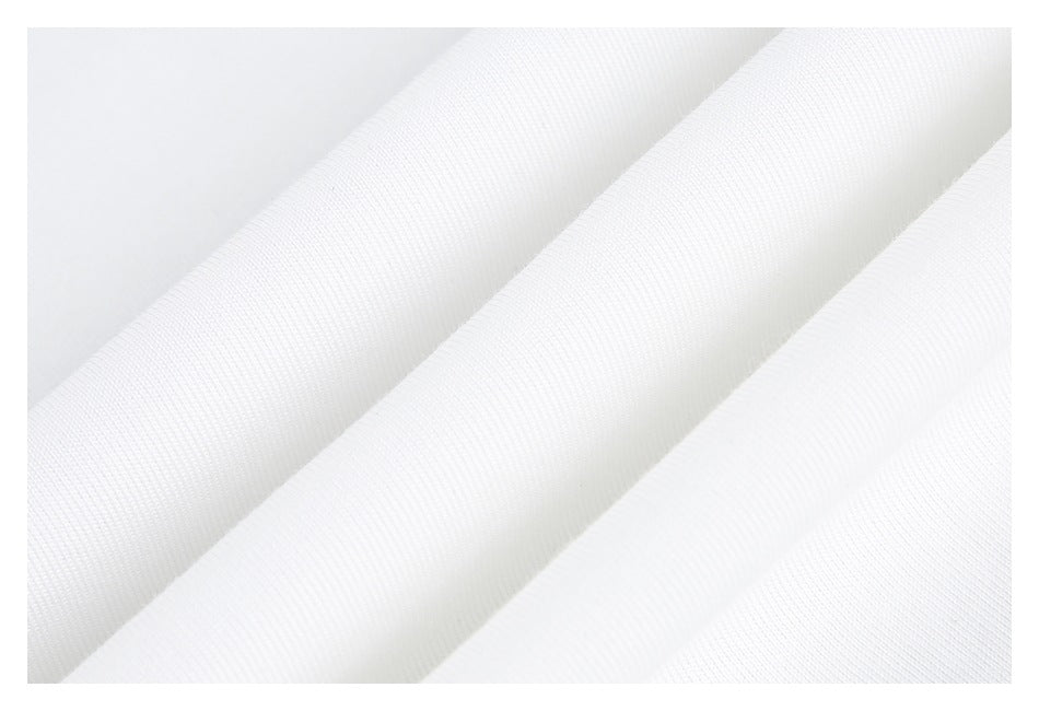 Close-up of white fabric arranged in diagonal folds, showing its fine knit texture.