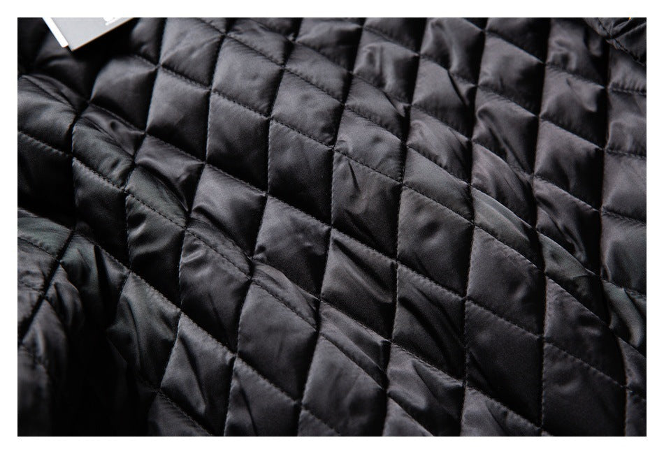 Close-up of the black diamond-quilted lining, with a small portion of a tag visible at the edge.
