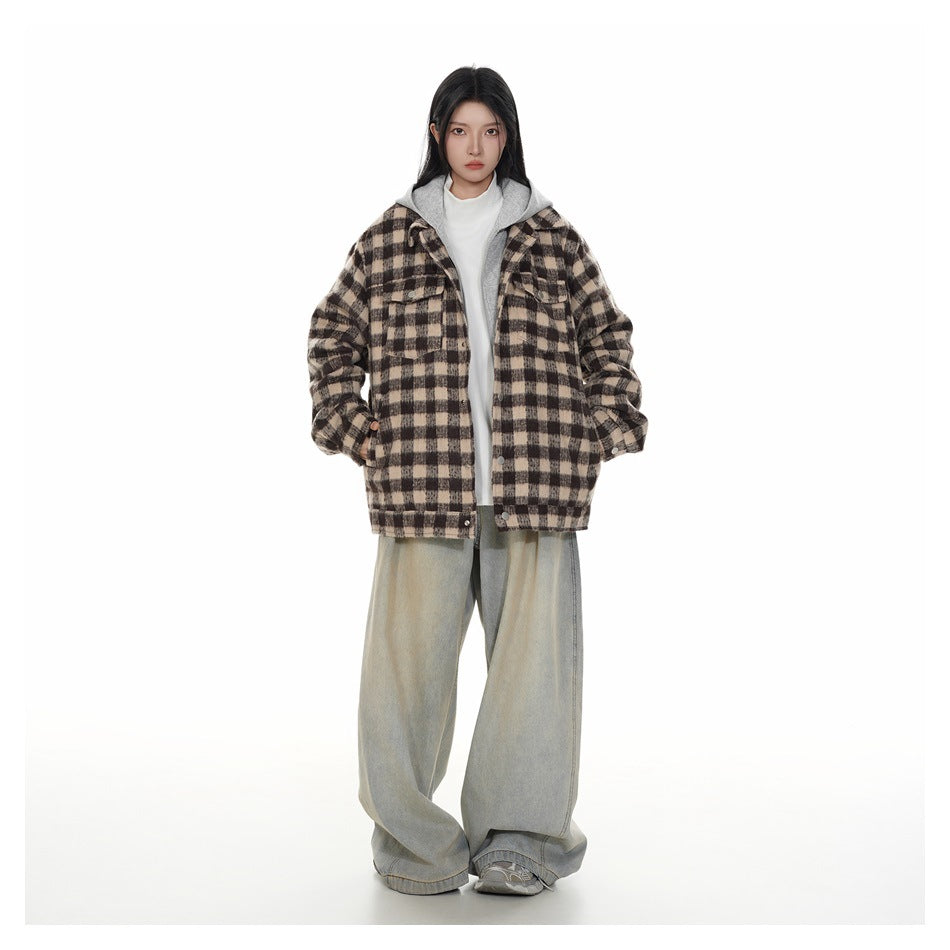 Full-length front view of a model in a brown and beige plaid hooded jacket and loose light-wash jeans.