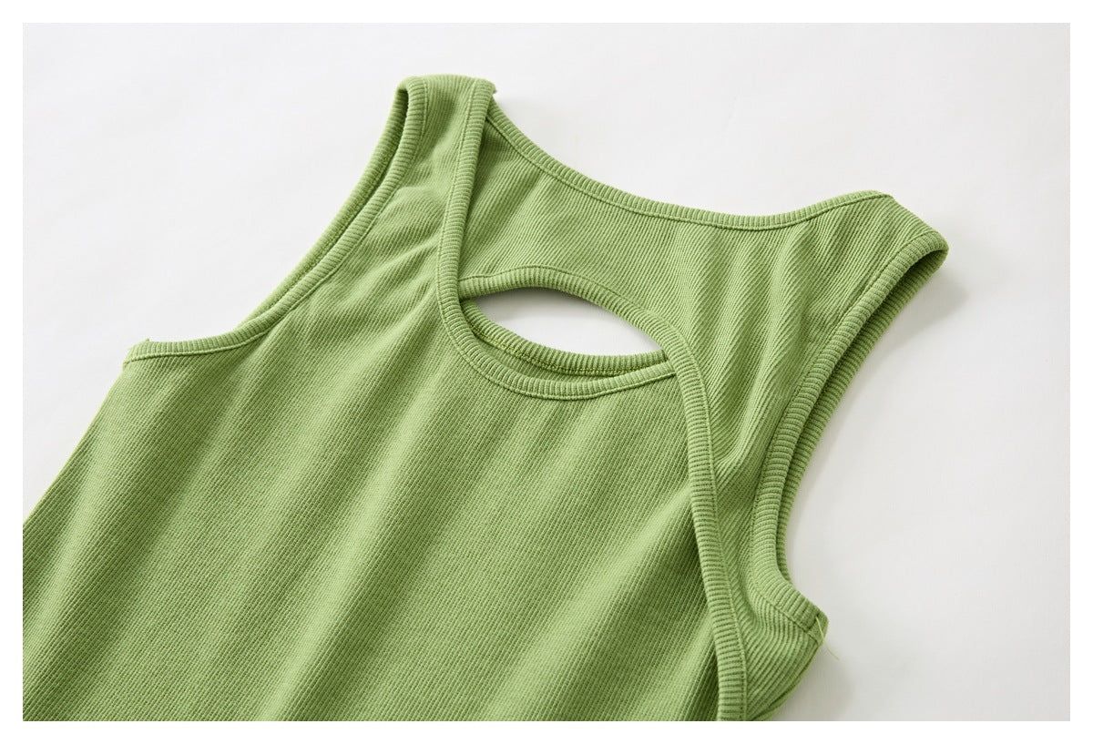 Close-up of a light green ribbed sleeveless top with wide straps and an oval cutout opening.
