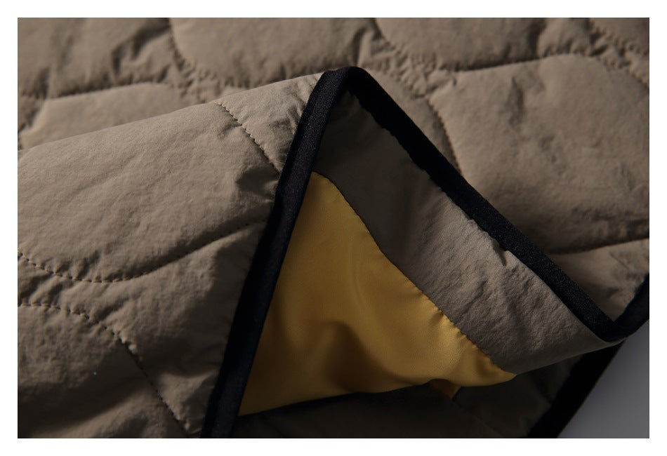 Close-up of the jacket’s black binding and yellow lining at an opened edge.