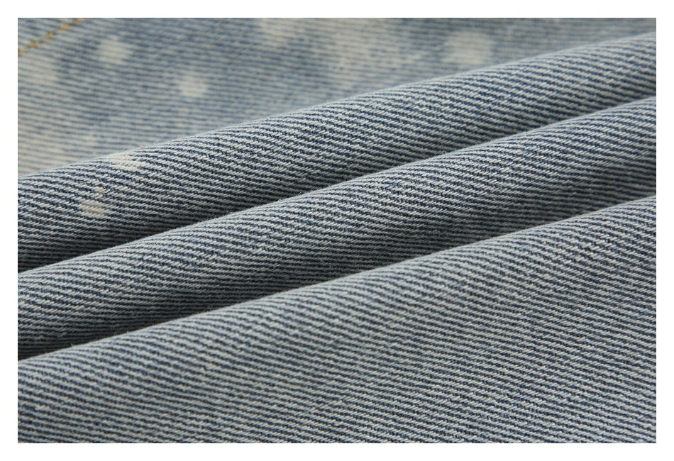 Close-up of blue-and-white diagonal denim twill arranged in broad folds.
