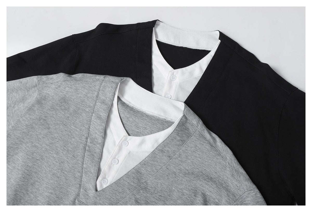 Overlapping black and heather gray V-neck tops with white button-front inner panels, shown flat.
