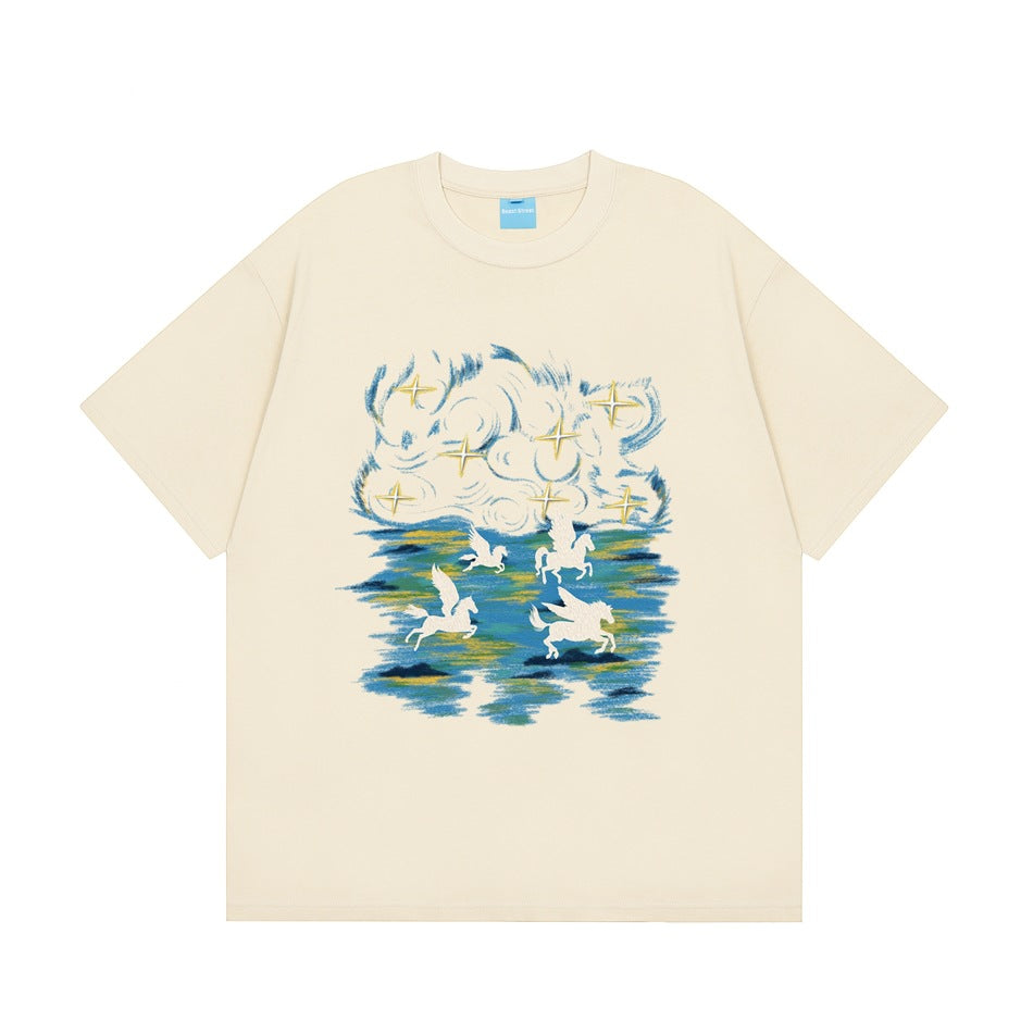Apricot short-sleeve crew-neck T-shirt with a blue and gold brushstroke print of winged horses, clouds and stars