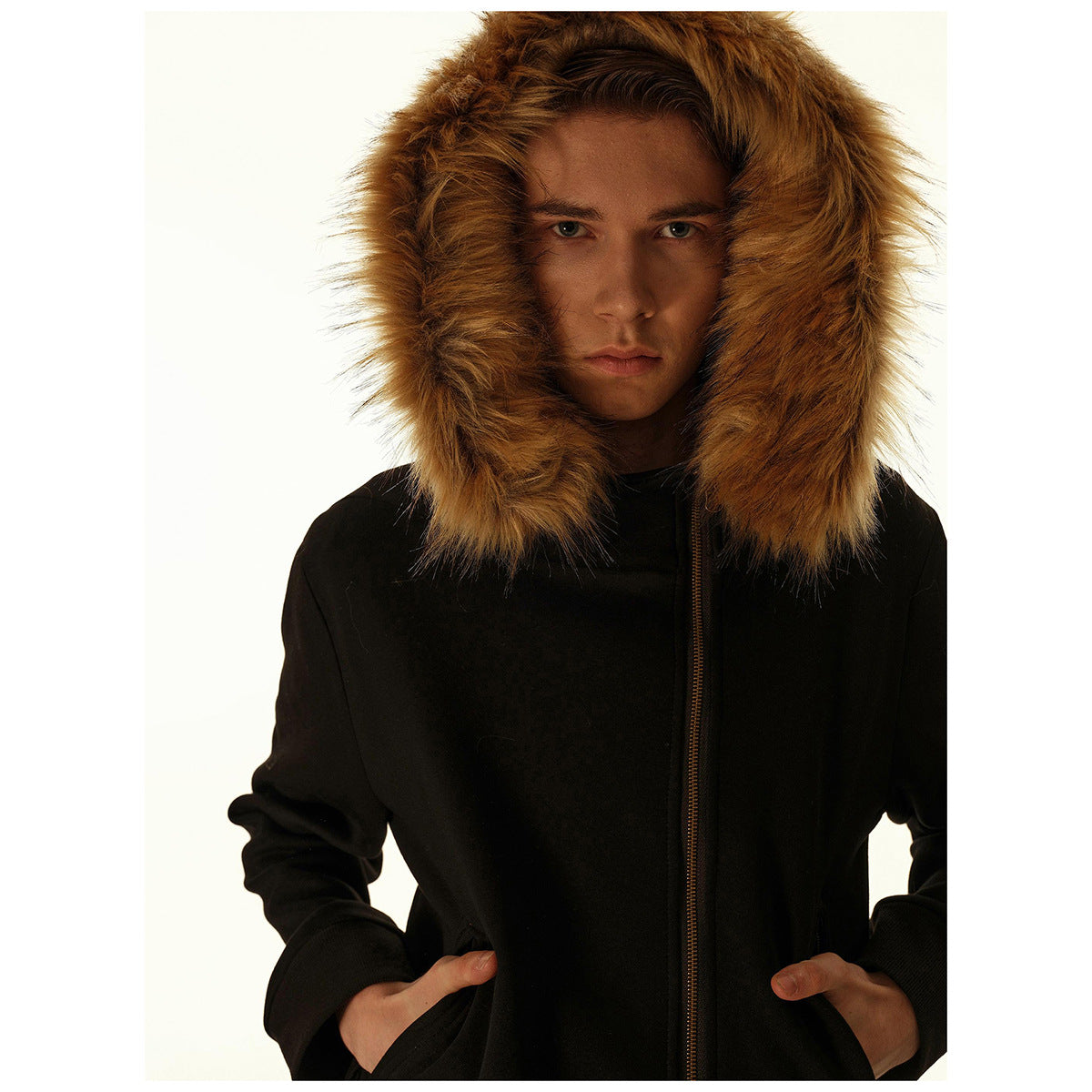 Close view of a man wearing a black zip-front jacket with a large tan fur-trimmed hood.
