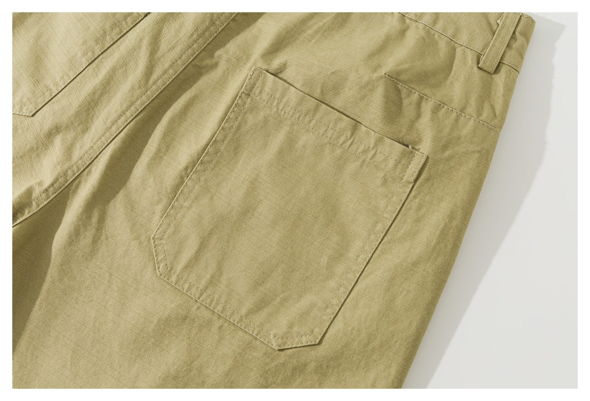 Close-up of a large patch pocket and belt loop on the back of the khaki shorts.